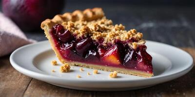 Single slice of plum pie with crumbles topping on plate. photo