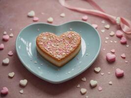 Heart shaped plate with heart sweet St Valentine's Day concept Minimal pastel combination. photo