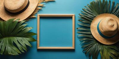 Summer flat lay with empty picture frame surrounded by tropical palm leaves and straw hat on blue background. photo