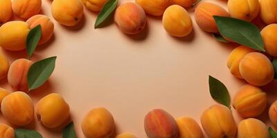 frame made of delicious apricots with leaves on orange background with copy space in the middle. photo