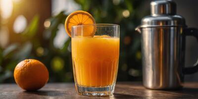 Freshly squeezed orange juice in a tall glass next to ripe oranges. photo