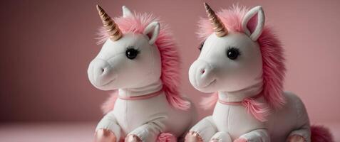 Cute soft unicorn plush toy on pink background. photo
