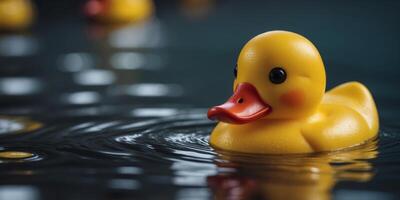 A small rubber yellow duck swims in the water in the pool. photo