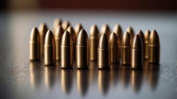 A row of bullets are lined up on a table. photo