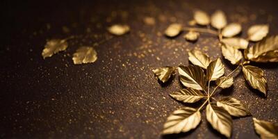 A gold leaf design is on a brown background. photo