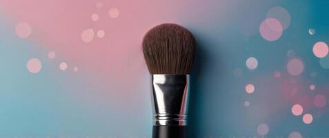 Close up of a makeup brush on pink and blue background. photo