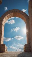 Bright blue sky with fluffy clouds viewed from an archway. photo