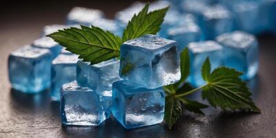 A bunch of blue ice cubes are on a table next to some marijuana. photo