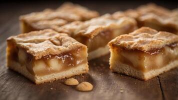 apple pie bars with a shortbread crust and spiced apple filling presented on a rustic wooden table. photo