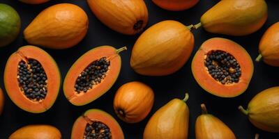 flat lay top view of of papayas fruit on black surface background. photo