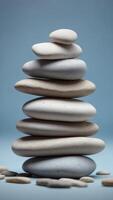 Stack of smooth white stones on a pale blue background. photo