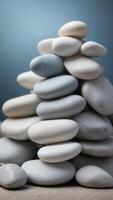 Stack of smooth white stones on a pale blue background. photo