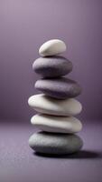 Stack of smooth white stones on a purple background. photo