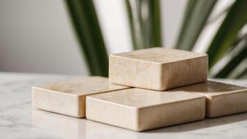 two square beige travertine coasters on a white surface with palm leaf shadows. photo