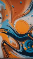A colorful graffiti mural with a blue and orange swirl. photo