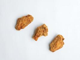 Fried chicken wings on white background top view photo