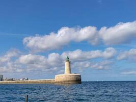 Lighthouse on a Bright and Sunny Day Beacon of the Coastline. photo