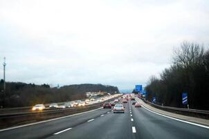 Traffic on highway in the cloudy day photo