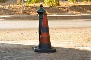Urban Street Scene with Weathered Traffic Cone and Old Fire Hydrant photo