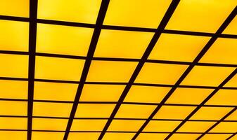 Black line on yellow isolate background, Metal grid painted in black isolated on yellow , Create visual impact with graphic patterns and ink splatters. Diagonal cells pattern. Seamless. photo