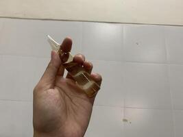 A Hand Holding a Glass Ampoule with Liquid mercury analyst photo
