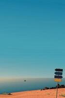 Minimalist seascape view from cliff with blank direction signboard pole have blue sky vertical background graphic illustration. vector
