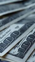 Hundred dollar bills spinning. Rotation of paper money. Background with american hundred dollar bills. Close-up. Vertical video