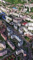 High-rise buildings in the city. Modern architecture on the urban background. Amazing view of a cityscape. Top down view. Vertical video