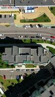 Modern city. Urban district with architecture and road filled with moving cars. View from above. Motion camera top down. Vertical video