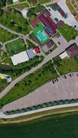 Resort complex for leisure activity. Modern recreation center with health attractions on nature background. Top aerial view. Vertical video