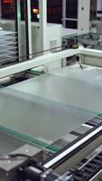 Robotic machine makes solar panel indoors. Automated technology of producing solar cells in a modern factory. Vertical video
