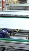 Working factory mechanism of making solar panels. Automated equipment for doing solar energy production. Innovation technology concept. Vertical video