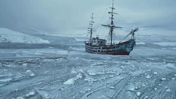 A ship in the middle of a large body of water surrounded by ice video