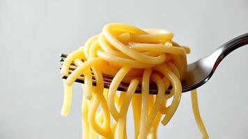 Fresh noodles on a fork on a white background photo
