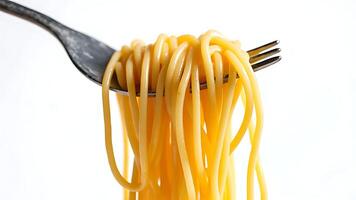 Fresh noodles on a fork on a white background photo