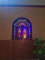 A wooden window creates different colors while turning on the light from inside photo