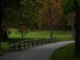 Benches in the shade of trees. Park Turkenschanzpark in Vienna in autumn photo