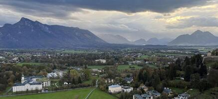 Panoramic view of Salzburg with mountains at the background in the evening at sunset. Banner background format photo
