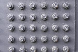 a close up of a metal wall with many holes photo