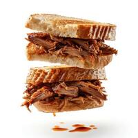 a cut in half sandwich sitting on top of a white table photo