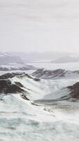 large snow patch left over on the volcanic rock field of a mountain in summer video