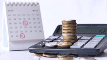 Calculator and coins on a desk video
