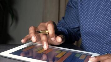 A man using a pen to write on a tablet video