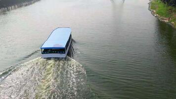 A boat traveling down a river with a bridge in the background video