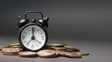An alarm clock and coins on a table video