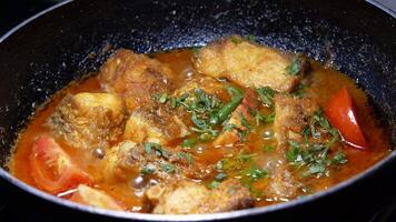 A pan with some fish and tomatoes in it video