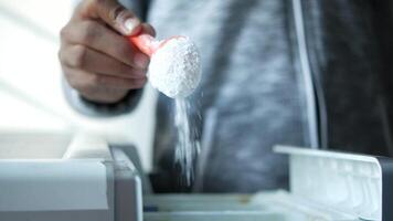 A person is using a spoon to scoop out some sugar video