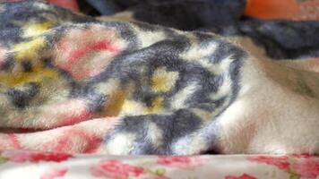 A pile of blankets with a colorful pattern video