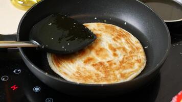 A pancake being cooked in a pan with a spatula video