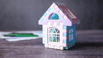 A small toy house with a window on a table video